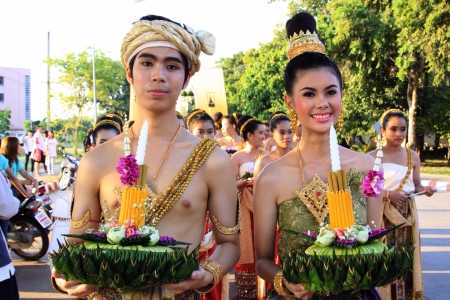 Cheerful Thai man and woman holding krathong and smile with traditional cloth in Loy krathong festival Thailand. の素材