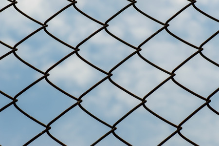 Wire mesh or netting fence against the sky