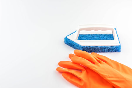 rubber gloves and brush for cleaning on white backgroundの写真素材