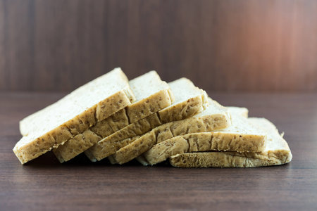 Sliced Whole wheat bread on wood table, selective focus.