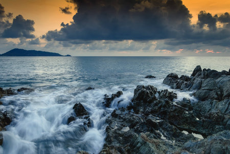 Seascape of wave on rock , Long Exposure at Sunset on the beach in Phuket Thailand.の写真素材