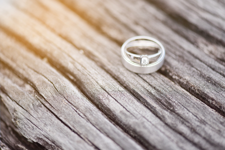 Wedding rings on wooden backgroundの写真素材
