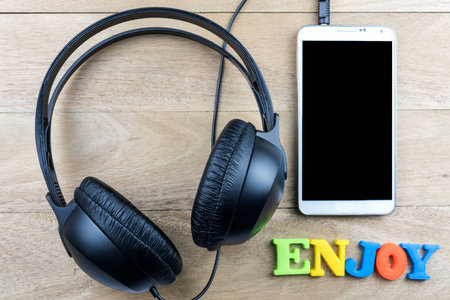 Black headphones and smartphone on wooden backgroundの写真素材