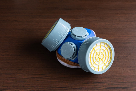 Respirator mask, dust mask  and safety mask for chemical industrial on wooden background.の写真素材