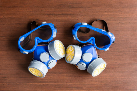 Respirator mask, dust mask  and safety mask for chemical industrial on wooden background.