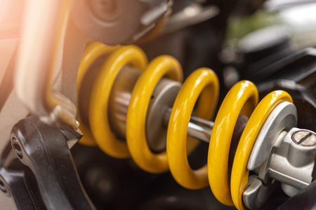 Closeup of springs, yellow shock absorbers motorcycle big bike, selective focus.の写真素材
