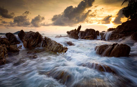 Seascape with rock in sunset scenery background, Seascape during storm and sunrise, Long exposure image of Dramatic sky.の写真素材