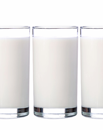 fresh milk in the glass on white backgroundの写真素材