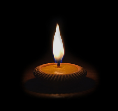 Candles in pottery black background.の写真素材