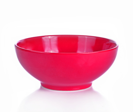 Empty red ceramic bowl isolated white backgroundの写真素材