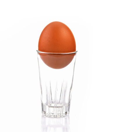 Egg in glass isolated white backgroundの写真素材