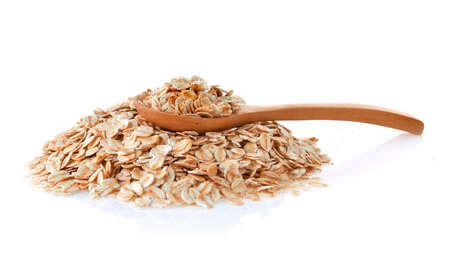Rolled Oats in spoon wooden isolated on white backgroundの写真素材
