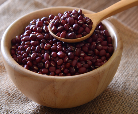Red bean or azuki in wood bowl ,spoon wood on Sack floorの写真素材