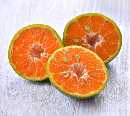  Tangerine half cut on table wooden backgroundの写真素材