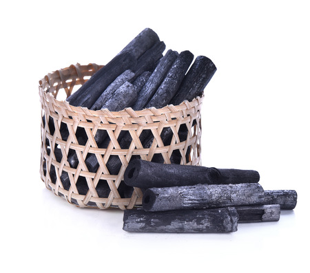 Charcoal  in a bamboo basket isolated on white backgroundの写真素材
