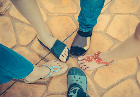 Feet of men and women on the ground.の写真素材