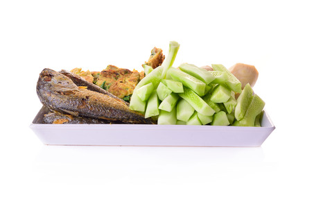 Fish dish - fried fish fillet with vegetables on white backgroundの写真素材