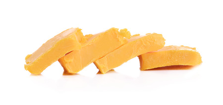 Stick of butter, cut, isolated on white.の写真素材