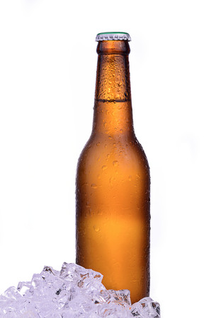 Bottle of beer with drops and ice isolated on white backgroundの写真素材