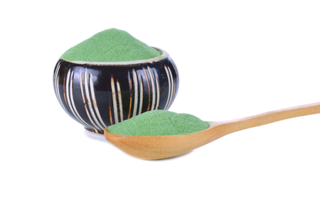 green powder and ceramic cup isolated on white backgroundの写真素材