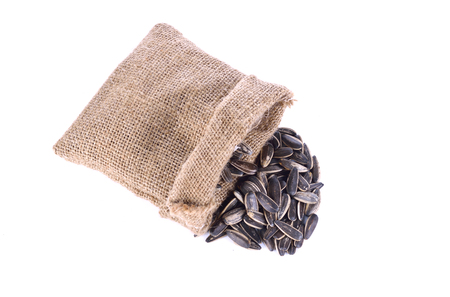 Sunflower seeds in Hemp sack isolated on white background close-upの写真素材