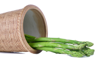Asparagus in a ceramic pot isolated on white background.の写真素材