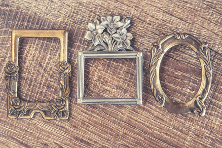 Vintage frames on a wooden background. Cross processed image for vintage lookの写真素材