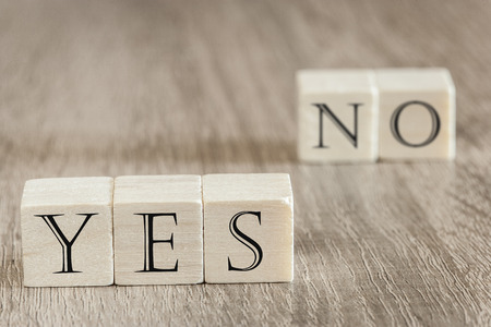 Dilemma  Decision concept. Wooden blocks forming Yes and No words. Image with selective focusの写真素材