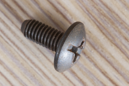 Used screw on a wooden benchの写真素材