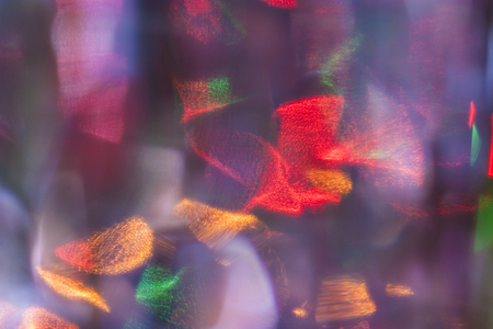 Abstract colorful background. Defocused blurred lights behind a glass surfaceの写真素材