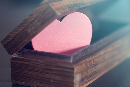 Valentine's red heart in a box. Love concept. Selective focus image cross processed for vintage lookの写真素材