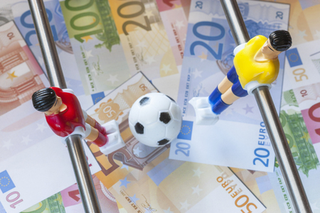 Sports and money. Concept about money spending in football soccer, sports betting and manipulated fixed matches. Selective focus imageの写真素材