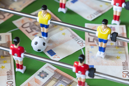 Sports and money. Concept about money spending in football soccer, sports betting and manipulated fixed matches. Selective focus imageの写真素材