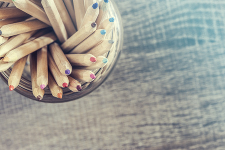 Color pencils on wooden table. Selective focus image with vintage filterの写真素材