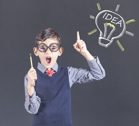 Little genius boy having an idea. Education, innovation and creativity concept