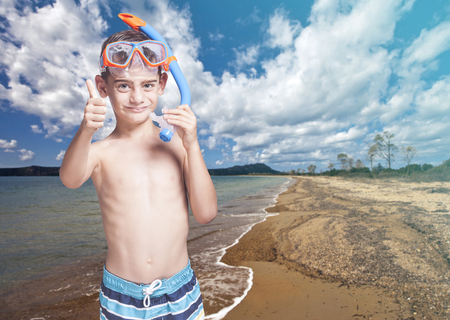 Cute little boy with snorkeling mask enjoying his summer vacationsの写真素材