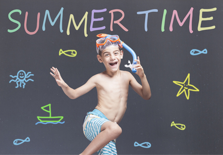 Summertime concept. Excited little boy with snorkeling mask ready for his summer vacationsの写真素材