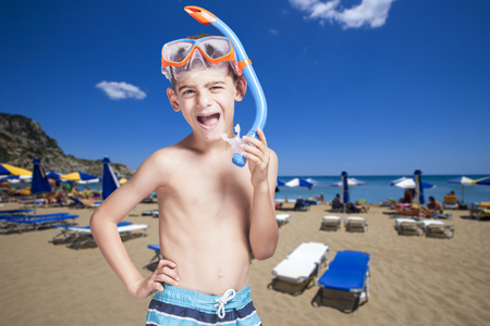 Happy little boy with snorkeling mask enjoying his summer vacationsの写真素材