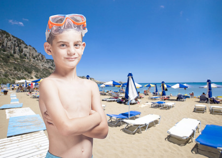 Summer vacation concept with cute little boy on the beachの写真素材