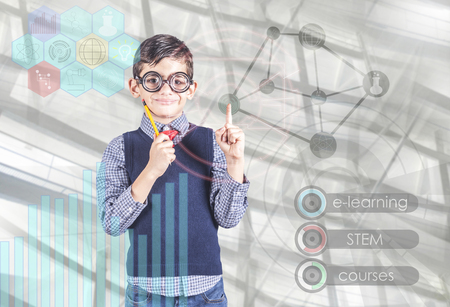 E-learning and futuristic STEM education technology concept with little school boy using digital hud interface and icons. (Image with mixed digital effects)の写真素材