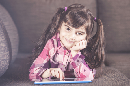 Cute little girl using a tabletの写真素材