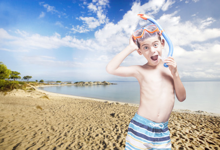 Happy little boy with snorkeling mask enjoying his summer vacationsの写真素材