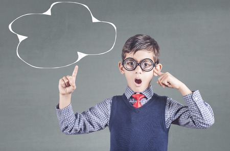 Education, innovation and creativity concept with little genius boy thinking hardの写真素材