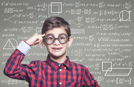 Back to school and education concept with genius school boy in classroom