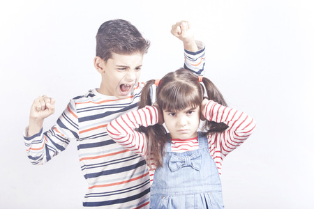 Brother yelling at his sister. Kids arguing conceptの写真素材