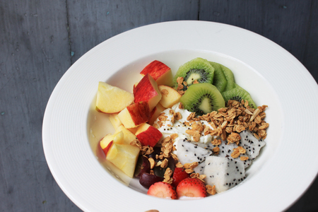 Healthy breakfast greek yogurt with granola and loads of fresh fruitの写真素材