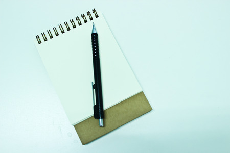 Notebook and Black Propelling Pencil Isolated on the White Backgroundの写真素材
