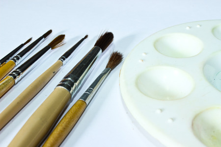 Watercolor Palette and Paintbrush Isolated on the White Background