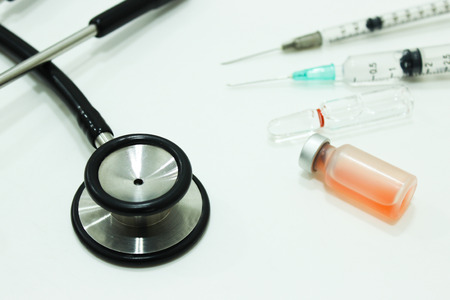 Stethoscope, Vial of Drug, 3 and 1 ml Plastic Syringe with Needle Isolated on the White Background, Focus on Stethoscopeの写真素材