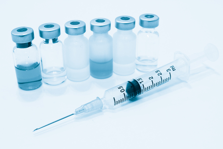Vial of Drug and 3 ml Plastic Syringe with Needle Isolated on the White Backgroundの写真素材